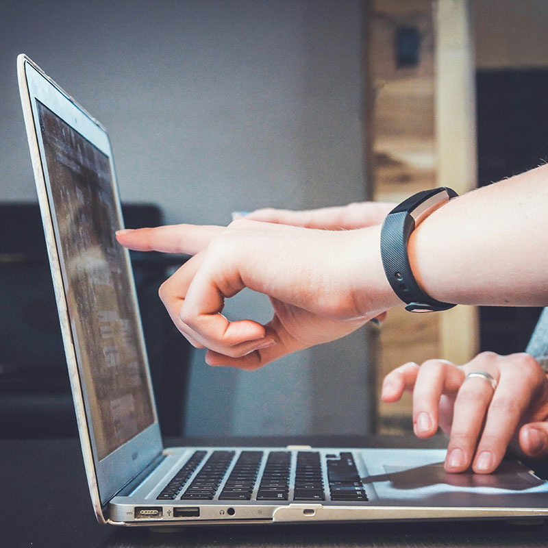 People working together around a laptop